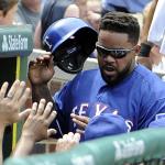 Texas&rsquo; Prince Fielder is greeted after scoring a run against the Chicago Cubs on July 17. Fielder confirmed today at a news conference that he will be forced to retire from baseball after a second neck surgery. (AP Photo/David Banks)