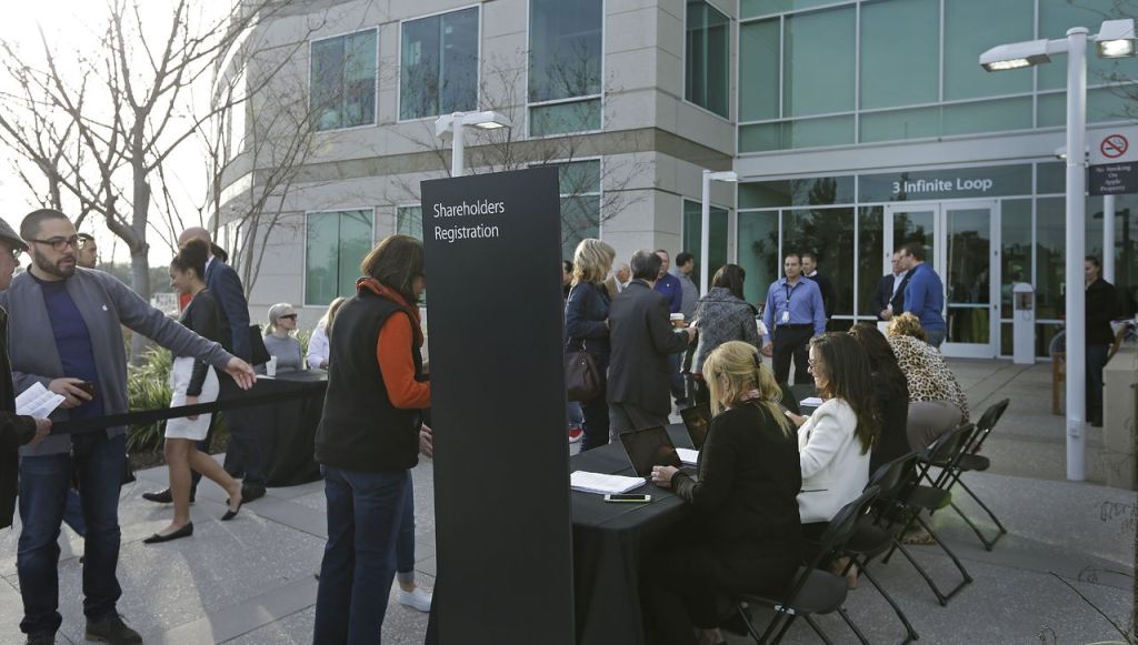 Apple shareholders register for the annual shareholders meeting Friday at Apple headquarters in Cupertino, California. Apple CEO Tim Cook defended his company&rsquo;s opposition to the FBI&rsquo;s iPhone-hacking plan at the company&rsquo;s annual shareholder meeting, one day after the tech giant formally challenged a court order to help the FBI unlock an encrypted iPhone used by a murderous extremist in San Bernardino, California.