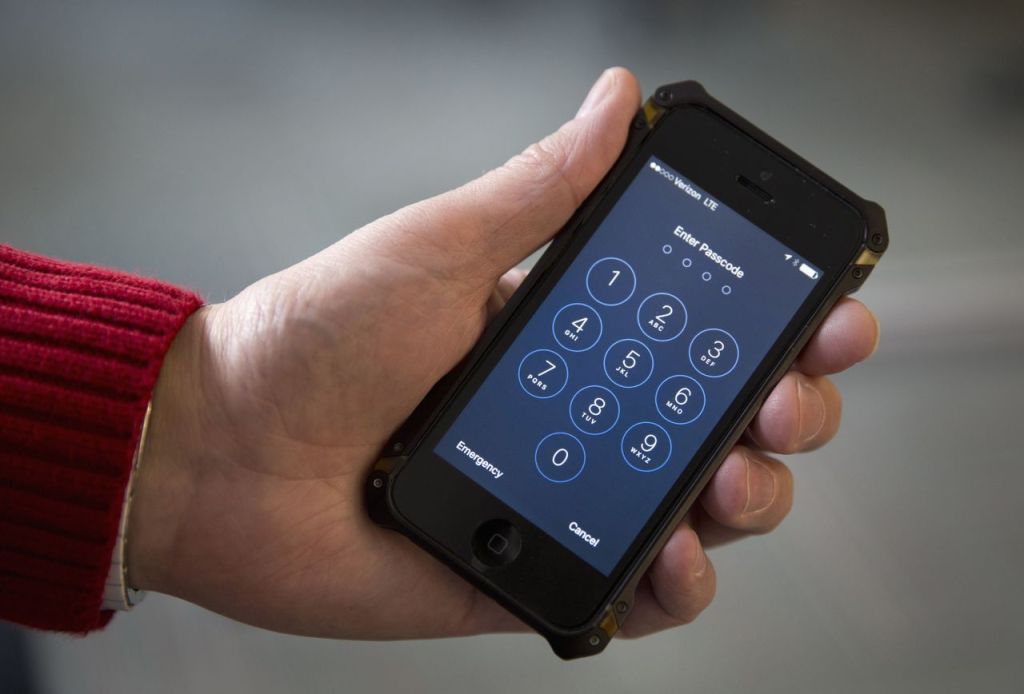 FILE - In this Feb. 17, 2016 file photo shows an iPhone in Washington. A schism has emerged among family members of victims and survivors of the San Bernardino, California terrorist attack, with at least a couple supporting Apple Inc. in its battle against a federal court order to help the FBI hack into a shooter&rsquo;s locked iPhone. (AP Photo/Carolyn Kaster)