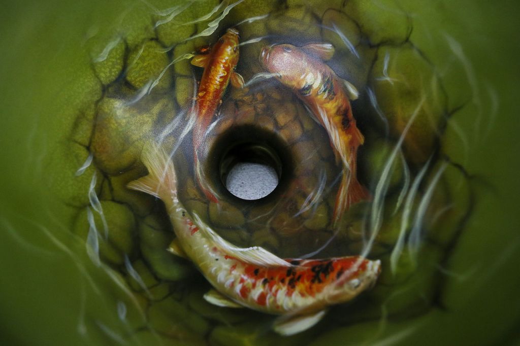 A custom airbrushed sink featuring carp swimming around the drain is seen at Mike Lavallee&rsquo;s Killer Paint studio in Snohomish.