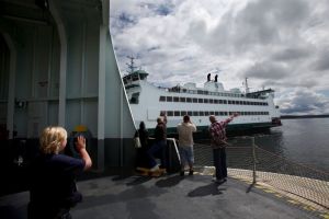 Michael O&rsquo;Leary / Herald file photo, 2011 Washington State Ferries has released its spring 2016 sailing schedules. Here, visitors to the Salish wave to the Chetzemoka as it sails from Port Townsend to Keystone on June 30, 2011.