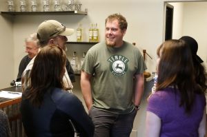 Temple Distilling&rsquo;s AJ Temple (center) visits with visitors at the distillery&rsquo;s limoncello release party earlier this month.