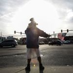 Samiu Bloomfield, 66, waves to passing motorists in Everett.