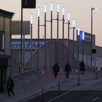 Pedestrians walk over Broadway Bridge in Everett on Thursday.