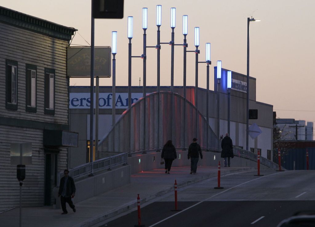 Pedestrians walk over Broadway Bridge in Everett on Thursday.
