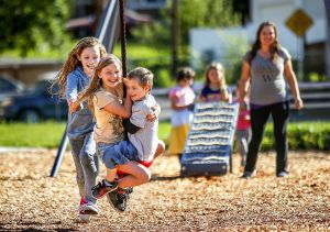 Chased by her friend and neighbor, Layla Taylor (left), 11, Amberle Peterson, 10, and her brother, Noah, 4, fly through the air on a zipline as their mom, Brandy Peterson, watches Monday at Henry M. Jackson Park, a few blocks from their homes in Everett.