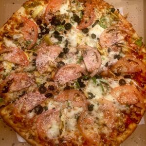 The veggie pizza at Lombardo&rsquo;s Pizzeria in Mukilteo is topped with mushroom, garlic, bell peppers, olives, artichoke hearts and sliced tomatoes.