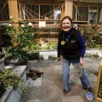 Fancy Fronds Nursery owner Judith Jones laughs after putting on a few final touches to her display at the Northwest Flower and Garden Show. Jones has been participating in the annual show since 1989.