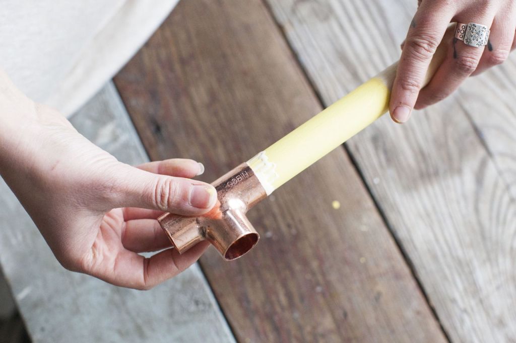 Step 4: Slip on a tee fitting using one of the holes along the top part of the &ldquo;T.&rdquo;