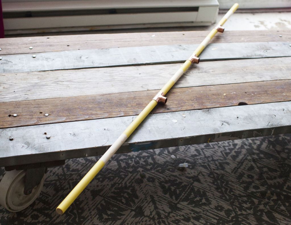 Step 6: Repeat this process until you have three 12-inch dowels connected to three tees. Add one 24-inch dowel to the bottom tee hole, again using wood glue.