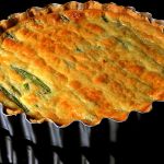 Asparagus spears are laid out side by side in this tart made with goat cheese.