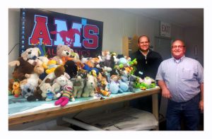 Ben Lamb, project manager (left), and Mike Perry, project superintendent with Skanska display stuffed animals they and their colleagues on the new Alderwood Middle School project donated to the Martha Lake Elementary PTA&rsquo;s Teddy Bear Patrol drive. The drive ultimately brought in more than 1,000 stuffed animals for Fire District 1.