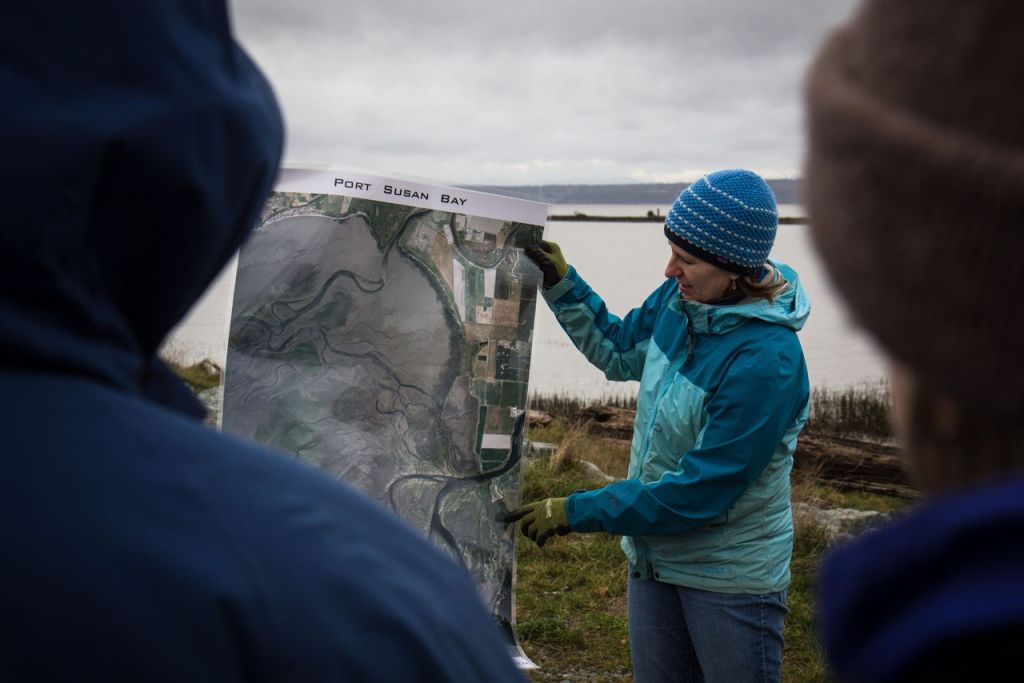 Jolene Boyd, one of the project coordinators for the Nature Conservancy, explains the geography of Port Susan Bay before volunteers began setting up bird boxes and gourds Saturday near Stanwood.