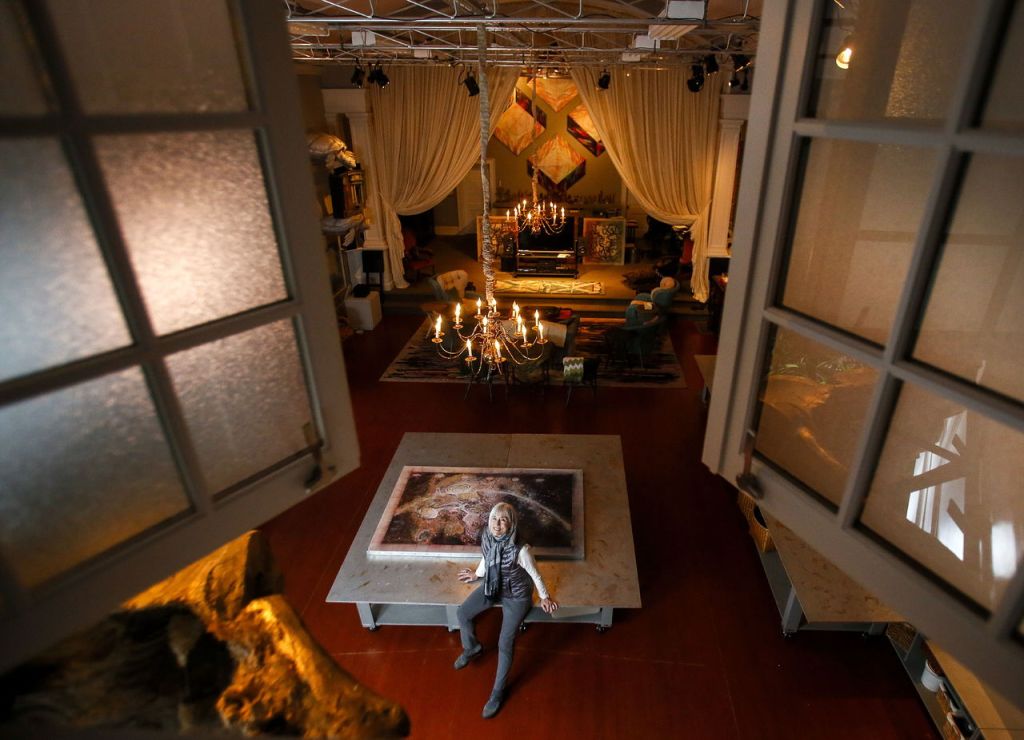 Karen Guzak and partner Warner Blake remodeled an old church as a home, office and art studio. What used to be the balcony seating area is now a bedroom that looks down through windows at the former sanctuary with Guzak&rsquo;s art studio, foreground, and beyond to a large, comfortable living space.