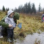 Jason Saura (left), of Kirkland, helps his 2-year-old son, Lincoln, collect insects at the Brightwater Treatment Plant&rsquo;s Education and Community Center in Woodinville.