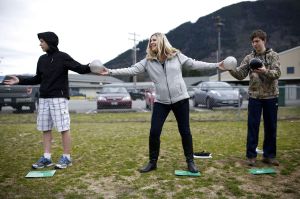 Darrington Middle School teacher Melissa Cumming passes balloons along with students during an exercise to simulate carbon emissions outside the school on Wednesday.