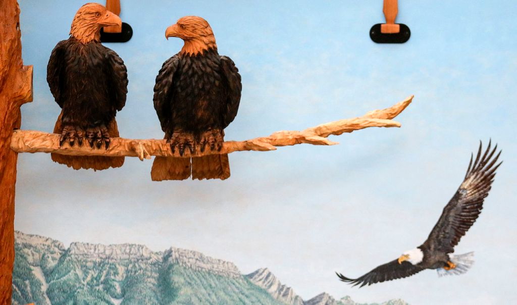 Carved wooden eagles perch on the branches of a towering fake tree in an atrium between the first and second floors of the new administrative building of the Stillaguamish Tribe in Arlington.