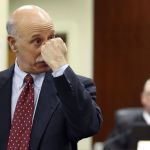 Paul Stern, Snohomish County deputy prosecutor, demonstrates a broken nose of the victim during his opening statements Wednesday morning at the Snohomish County Courthouse in Everett. David Morgan is accused of attempted murder and arson.