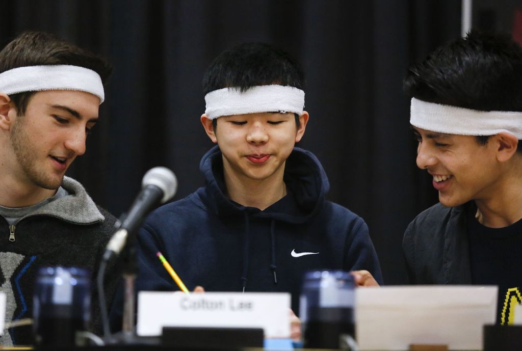 Jackson High School&rsquo;s Nich Feingold (left) and Jared Rodriguez (right) are amused by something in Colton Lee&rsquo;s penciled solution to a mathematical problem Tuesday during the first half of the Hi-Q tournament final against Monroe and Lake Stevens high schools.