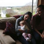 Elizabeth Bailey (center) holds her sister Anne Freeman&rsquo;s 3-month old daughter Kate in their grandfather Cliff Bailey&rsquo;s home on Springhetti Road in Snohomish on Wednesday.