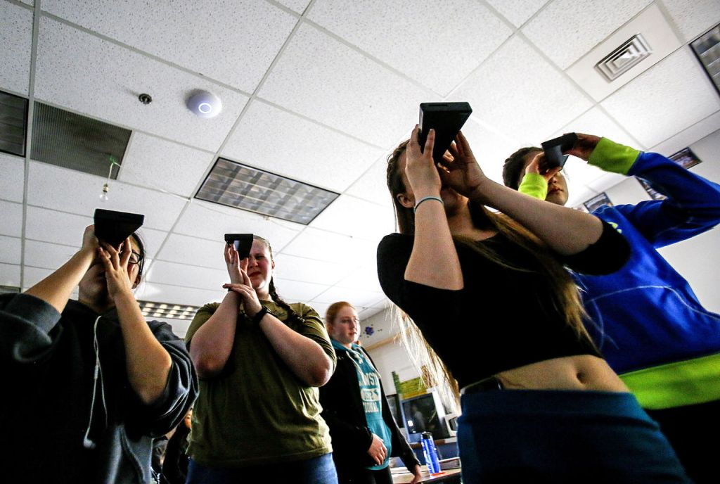 Students in science teacher John Hubbard&rsquo;s STEM class look through spectrometers to observe the colors of light that bulbs emit as electricity is applied. They then can attempt to identify the elements based on color.