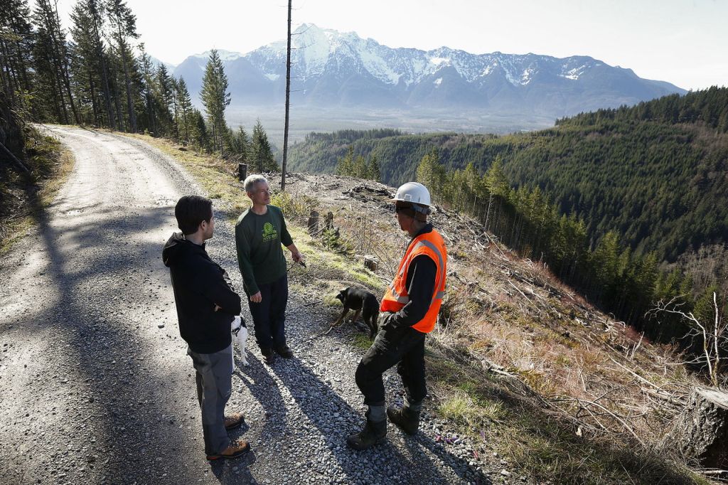 Mike Westra (center) and Mark Lovejoy (right), of the Evergreen Mountain Bike Alliance, talk with the Department of Natural Resources&rsquo; Sam Jarrett about plans for 20 miles of new mountain bike trails that will be built in the next 18 months near Darrington. They were scouting out the location of the project on North Mountain Road outside of town Thursday. The project aims to create new single track trails that mountain bikers of all experience levels can enjoy while also bringing business to the Darrington area.