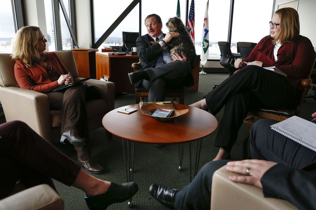 Snohomish County Executive Dave Somers (center) meets with Washington Environmental Council members Becky Kelley (left) and Darcy Nonemacher in his office in Everett on March 14. Hewitt, the executive&rsquo;s dog, often accompanies him to work.
