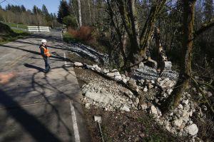 Work begins to reinforce Grade Road and help prevent further erosion caused by nearby Catherine Creek in Lake Stevens on Wednesday. The section of road, near the intersection of Grade Road and 32nd Street Northeast, has been closed for months and won&rsquo;t reopen until later this year.