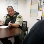 Craig Hess, a school resource officer with the Snohomish County Sheriff&rsquo;s Office, talks with a student involved in a dispute with a classmate at Sultan Middle School on Friday. Hess worked for the New York Police Department until leaving in 2005 to move to Washington.