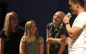 Brenda (from left), Emily and Haylie Nordstrom share a laugh with Sherwin Rulloda during a benefit concert at Marysville Nazarene Church on April 9. The proceeds went to the Nordstrom family to help with medical expenses.