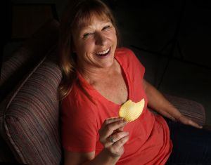 Relaxing at home Tuesday, a day after going through tedious preparation for cancer treatment, Kristine Moore can laugh about being called The Chip Lady.