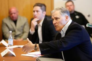 Washington state Gov. Jay Inslee asks questions after hearing the pitch.