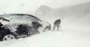 Lisa Rose tries dig her car out of a parking lot in Monument, Colorado, on Wednesday.