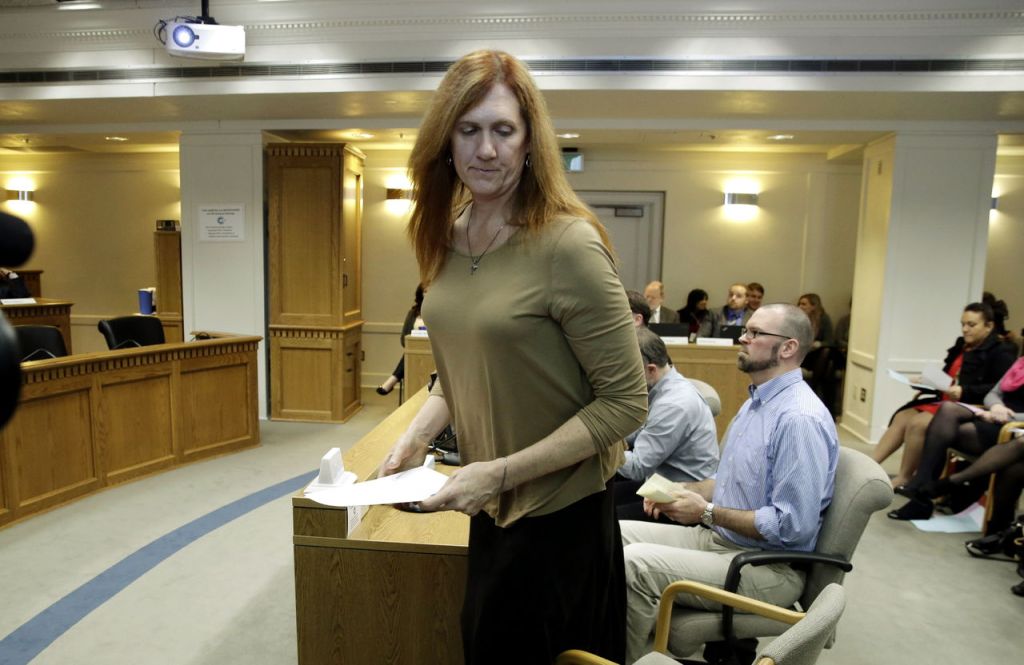 Ted S. Warren / Associated Press Kathryn Mahan, of Puyallup, who identifies herself as a transgender woman, stands up after testifying in opposition to a bill that would eliminate Washington&rsquo;s new rule allowing transgender people use gender-segregated bathrooms and locker rooms in public buildings consistent with their gender identity.