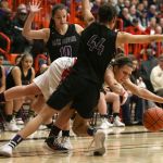 Snohomish’s Shaylee Harwood attempts to split the defensive pressure of Lake Stevens’ Laycie Taylor (left) and Kylee Griffen during the 4A District 1 championship game Thursday night at Everett Community College. Snohomish won 56-26.