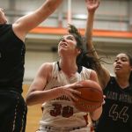 Snohomish&rsquo;s Madeline Smith goes up for a shot with Lake Stevens&rsquo; Hailey Wilson (left) and Kylee Griffen defending during the 4A District 1 championship game Thursday night at Everett Community College. Snohomish won 56-26.