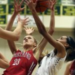 Stanwood’s Anna DePew and Lynnwood’s Jordyn Edwards vie for a rebound during the Royals’ 63-24 win over the Spartans in a 3A District 1 semifinal game on Wednesday.