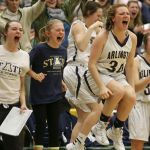 The Arlington bench celebrates a basket in the closing minutes of a 3A District 1 tournament semifinal game against Glacier Peak on Wednesday night at Shorecrest High School in Shoreline. Arlington won 52-45.