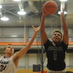 Jackson&rsquo;s Brian Brown (right) and Kamiak&rsquo;s Daniel Sharpe battle for a rebound during a 4A District 1 tournament game Saturday at Everett Community College. Kamiak won 62-58.