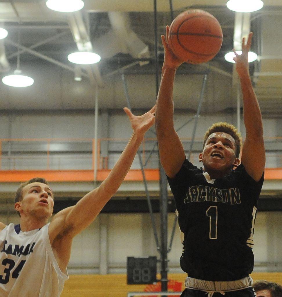 Jackson&rsquo;s Brian Brown (right) and Kamiak&rsquo;s Daniel Sharpe battle for a rebound during a 4A District 1 tournament game Saturday at Everett Community College. Kamiak won 62-58.