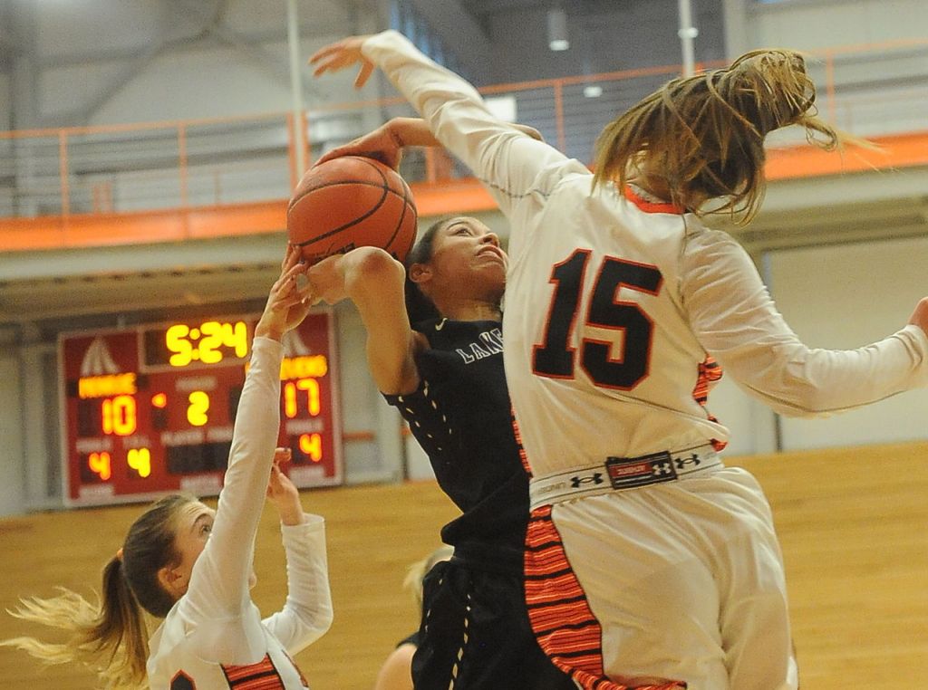 Lake Stevens&rsquo; Kylee Griffen splits the Monroe defense of Emily Donnelly (left) and Jadynn Alexander during a 4A District 1 playoff game Saturday at Everett Community College.