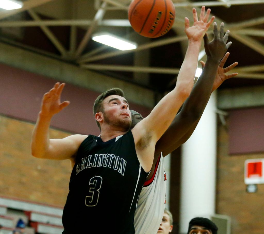 Arlington&rsquo;s Tylor Morton goes up for a rebound during a District 1 playoff game Friday against Mountlake Terrace at Mountlake Terrace High School.