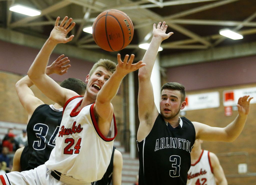 Mountlake Terrace&rsquo;s Gabe Altenberger (24) and Arlington&rsquo;s Tylor Morton (3) vie for a loose ball during a District 1 playoff game Friday at Mountlake Terrace High School.