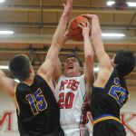 Marysville Pilchuck&rsquo; Josh Bevan (center) goes up for a shot with Ferndale&rsquo;s John Weg (left) and Riley Hunt defending during the first half of a 3A District 1 playoff game on Friday night in Marysville.