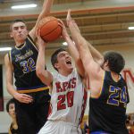 Marysville Pilchuck guard Josh Bevan (center) goea up for a shot with Ferndale&rsquo;s Dane Larsen (left) and Austin Honeycutt defending during a 3A District 1 playoff game on Friday in Marysville.