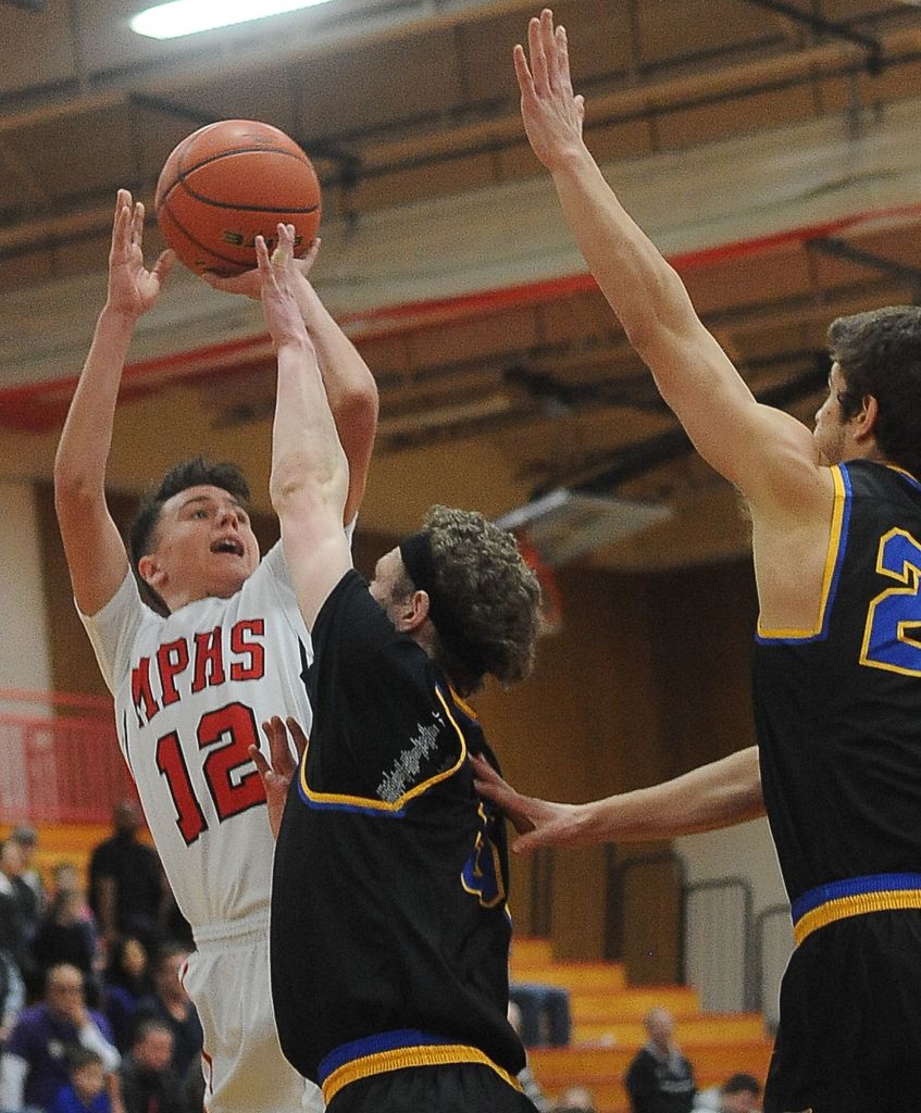 Marysville Pilchuck guard Josiah Gould (12) shoots a layup past Ferndale&rsquo;s Garett Holmes (5) during a 3A District 1 playoff game on Friday in Marysville.