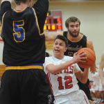 Marysville Pilchuck guard Josiah Gould (12) tries to break through the defense of Ferndale&rsquo;s Garett Holmes (5) during a 3A District 1 playoff game on Friday in Marysville.