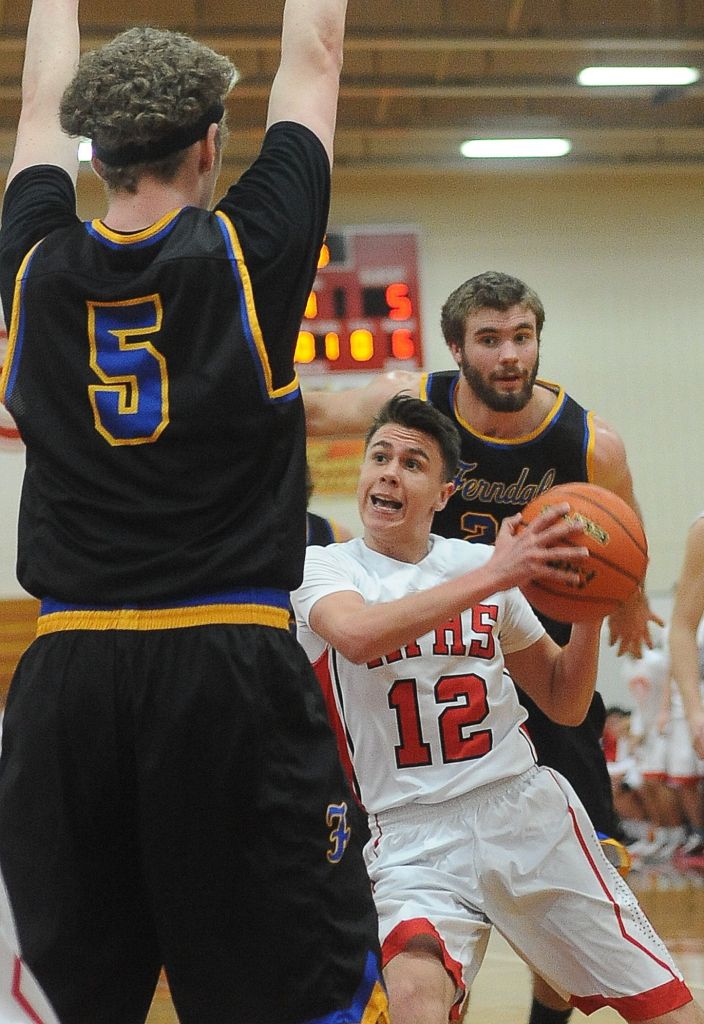 Marysville Pilchuck guard Josiah Gould (12) tries to break through the defense of Ferndale&rsquo;s Garett Holmes (5) during a 3A District 1 playoff game on Friday in Marysville.