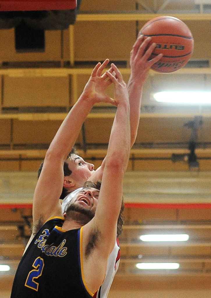 Marysville Pilchuck post Nate Heckendorf (back side) reaches for a rebound along with Ferndale&rsquo;s Sky Freeman (2) during a 3A District 1 playoff game on Friday in Marysville.