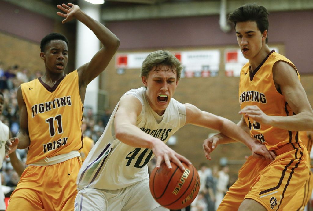 Edmonds-Woodway&rsquo;s Ryan Peterson (center) tries to keep a ball inbounds amidst O&rsquo;Dea defenders Xavier Smith (11) and Ben Johnson (13) during a 3A state regional game on Saturday at Mountlake Terrace High School.
